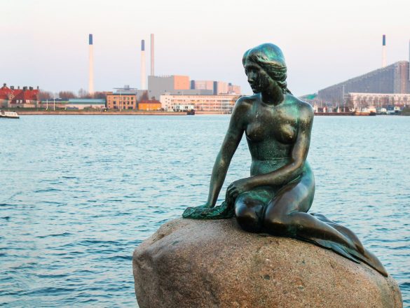 the statue of the little mermaid on a rock in copenhagen denmark