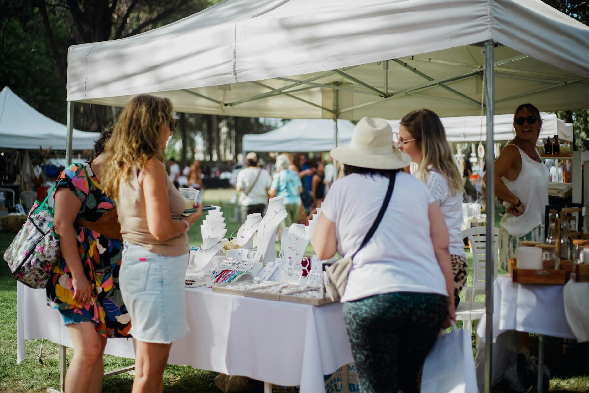 people standing by the jewelry exhibition at the market